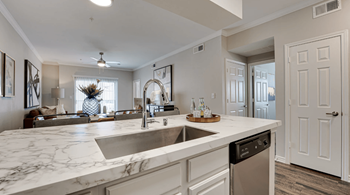 Open kitchen with a large counter top and a sink